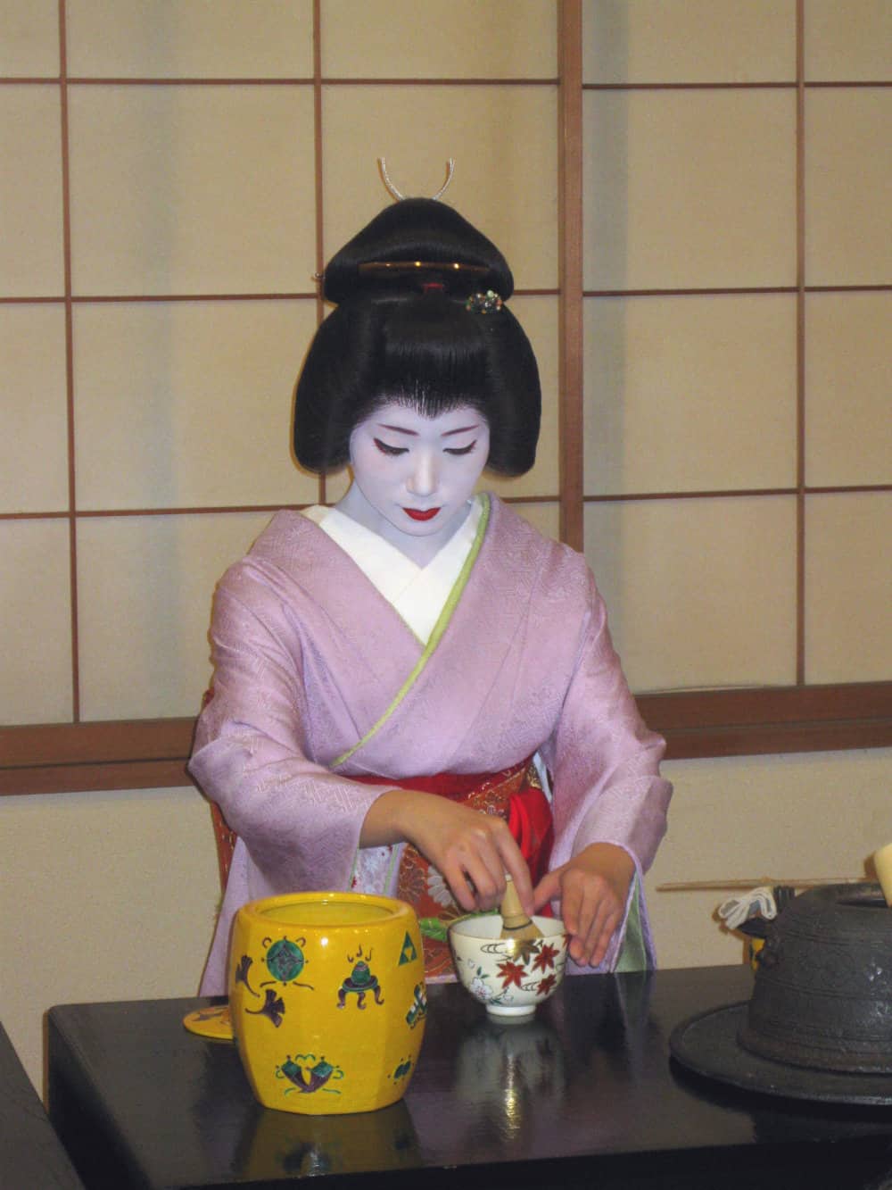 A geisha in Kyoto whisking up a bowl of green tea